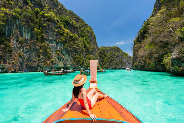 Boat ride over turquoise water at Phi Phi Islands, Thailand’s famous beach destination.