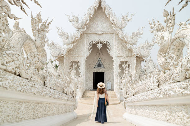 Wat Rong Khun, or the White Temple in Chiang Rai, is a striking contemporary Buddhist temple known for its intricate white design and symbolic journey toward enlightenment.