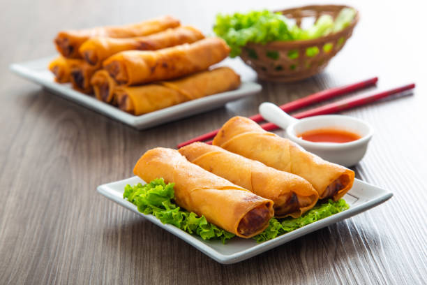 Poh Pia Tod, crispy Thai spring rolls filled with a savory mixture of vegetables and sometimes meat, typically served with a sweet chili dipping sauce.