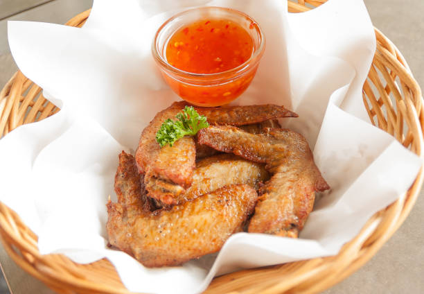 Gai tod nam pla is Thai-style fried chicken marinated in fish sauce, giving it a savory, aromatic flavor with a crispy skin.