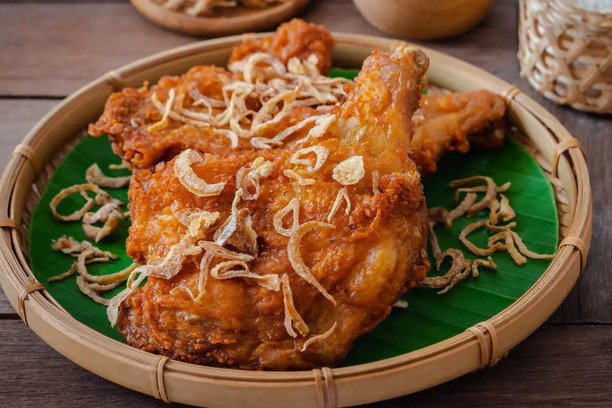 Gai Tod, a delicious Thai dish, features crispy fried chicken marinated in aromatic herbs and spices, often served with a tangy dipping sauce.
